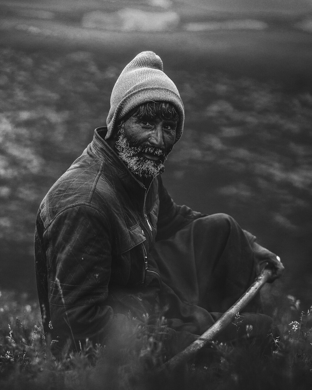 Portrait of an elderly Danish fisherman mending nets at the harbor