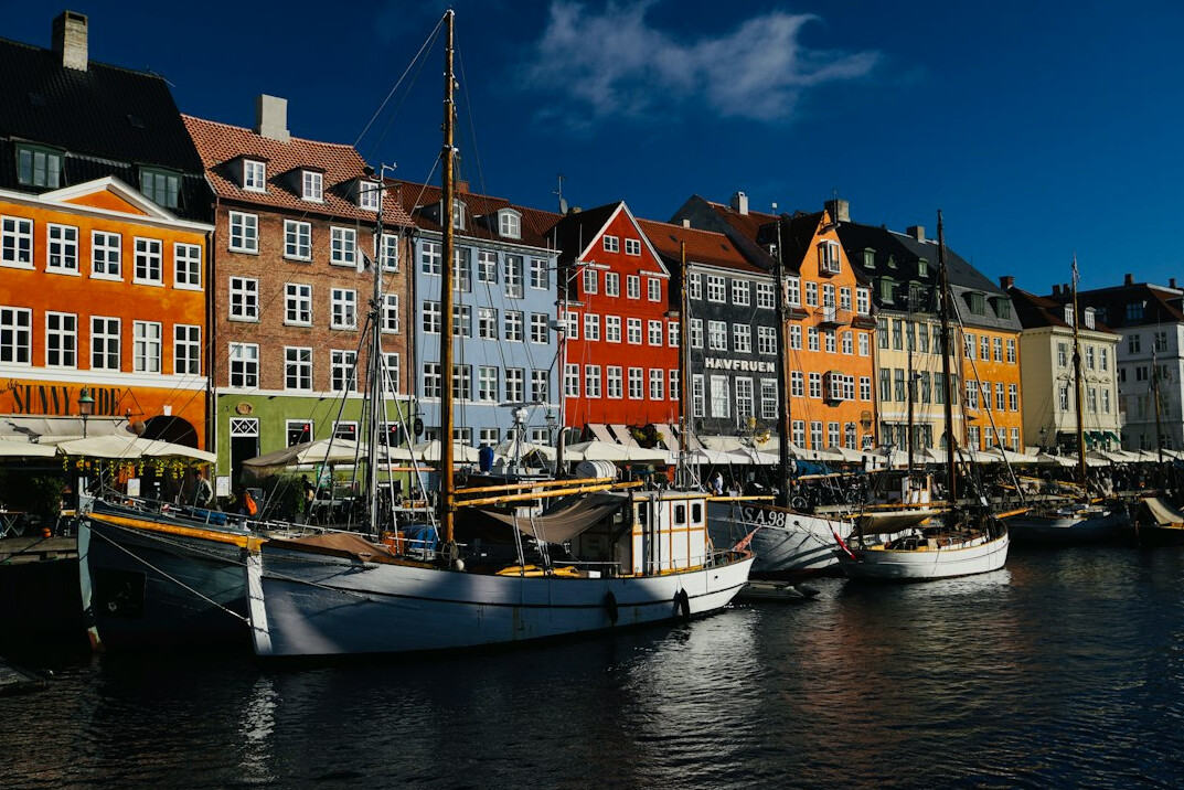 Colorful harbor houses and boats at Nyhavn canal in Copenhagen, Denmark