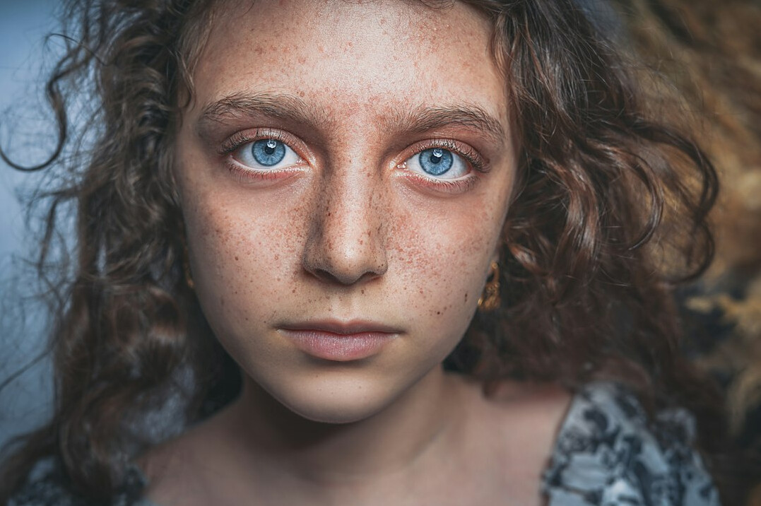 Close portrait of an elderly Danish woman with a weathered face and warm expression